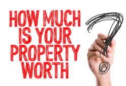 Hand with marker writing How Much Is Your Property Worth?.jpeg
