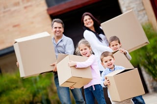 Happy family moving house and carrying boxes.jpeg