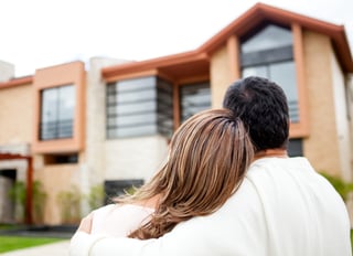 Loving couple looking at their dream house.jpeg