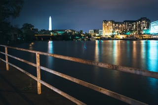 The Washington Monument and buildings along the waterfront at night in Washington, DC..jpeg
