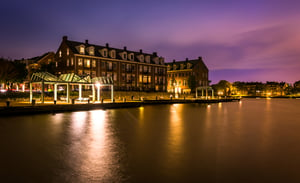 Waterfront condominiums and promenade along the Potomac River at night in Alexandria, Virginia.