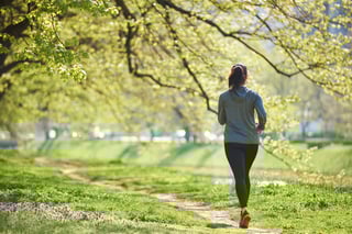 young woman jogging in city park at early morning.jpeg