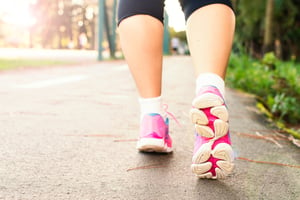 photo-of-woman-wearing-pink-sports-shoes-walking-1556710